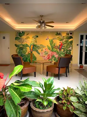 a room with a table and chairs and plants at Salin Home Hotel Ramkhamhaeng in Bangkok