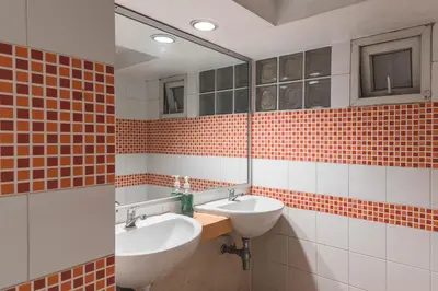 a bathroom with two sinks and a mirror at Happio Near Chabad House in Bangkok