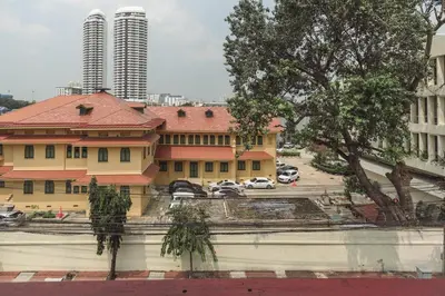 a view of a building and a parking lot at Happio Near Chabad House in Bangkok