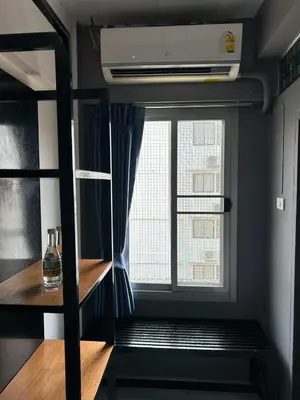 a room with a window and a bed in a room at Happio Near Chabad House in Bangkok