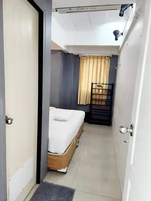 a small room with a bed and a window at Happio Near Chabad House in Bangkok