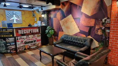 a waiting room with a leather couch and a table at Happio Near Chabad House in Bangkok