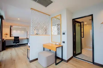 an office with a desk and a mirror at The Royal River Hotel in Bangkok