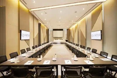 a large conference room with a long table and chairs at The Quarter Ari by UHG in Bangkok