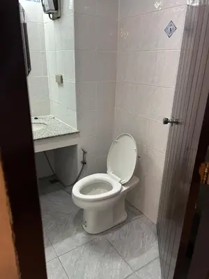 a bathroom with a white toilet and a mirror at Malaysia Hotel Bangkok in Bangkok