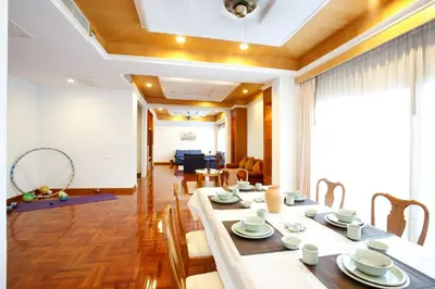 a dining room with a table and chairs at Chaidee Mansion in Bangkok