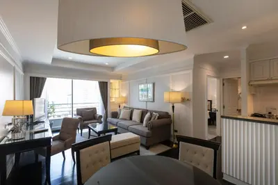 a living room with a couch and a table at Cape House Hotel, Bangkok in Bangkok