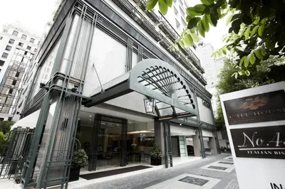 a building with a sign in front of it at Cape House Hotel, Bangkok in Bangkok
