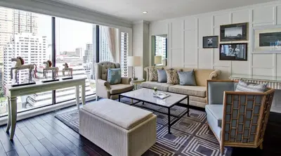a living room with a couch and a table at Cape House Hotel, Bangkok in Bangkok