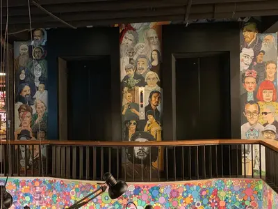 a wall with a mural of people on it at White Palace Bangkok in Bangkok