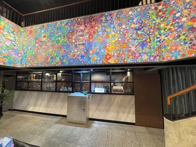 a large colorful mural on the wall of a restaurant at White Palace Bangkok in Bangkok