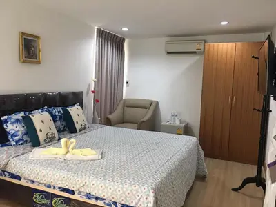 a bedroom with a bed with a yellow bow on it at Nineplace 46 in Bangkok