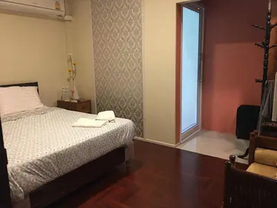 a bedroom with a bed with two towels on it at Nineplace 46 in Bangkok