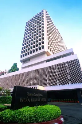 a tall building with a sign in front of it at Indra Regent Hotel in Bangkok