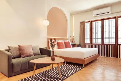 a living room with a couch and a table at House Of PaPa Bangkok Siam in Bangkok