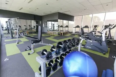 a gym with several treadmills and exercise machines at The SkyHouse Duplex - Luxury Home in Bangkok