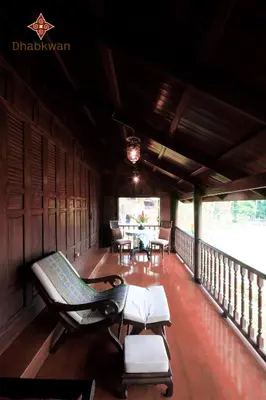 a room with chairs and a table on a balcony at Dhabkwan Resort in Nonthaburi