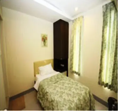 a small bedroom with a bed and a window at Nine Place Sukhumvit 40 in Bangkok