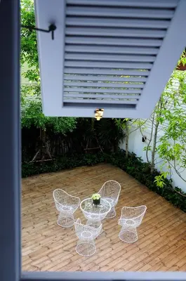 a group of chairs and a table on a patio at Baan Noppawong in Bangkok