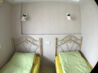 two beds sitting next to each other in a room at Roof View Place in Bangkok