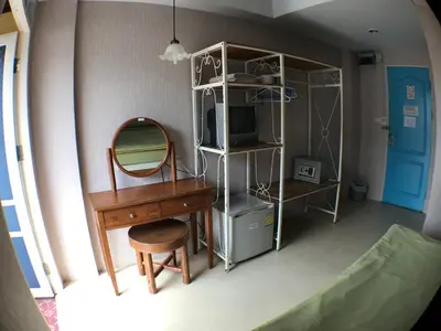 a room with a desk and a mirror and a dressing table at Roof View Place in Bangkok