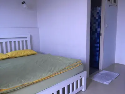 a small bedroom with a bed and a closet at Roof View Place in Bangkok