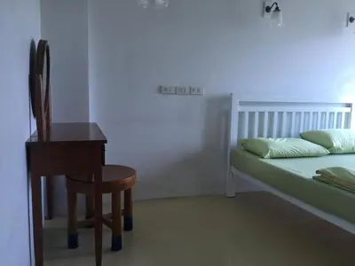 a bedroom with a bed and a chair and a desk at Roof View Place in Bangkok