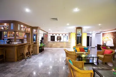 a lobby of a hotel with chairs and a bar at The Tarntawan Hotel Surawong Bangkok in Bangkok
