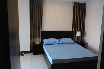 a bedroom with a blue bed in a room at Mok Mek 72 in Bangkok