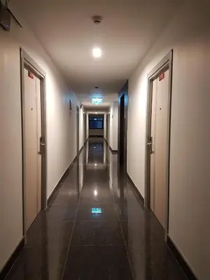 an empty hallway with two doors and a hallwayngthngthngthngthngthngthngth at DB Plus 2 in Bangkok