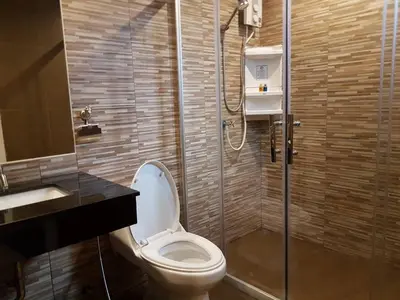 a bathroom with a toilet and a shower and a sink at DB Plus 2 in Bangkok