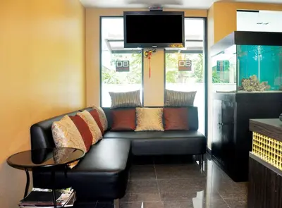 a living room with a couch and a tv at DB Plus 1 in Bangkok