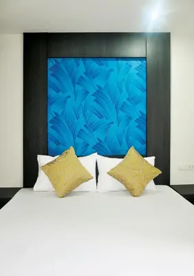 a bedroom with a large white bed with two pillows at DB Plus 1 in Bangkok