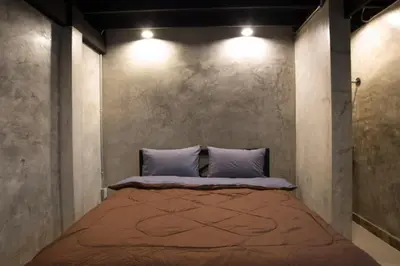 a bedroom with a large bed with two pillows at Sawatdee Guesthouse the Original in Bangkok