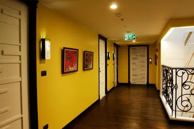 a hallway with yellow walls and a door at Aspira Skyy Sukhumvit 1 in Bangkok