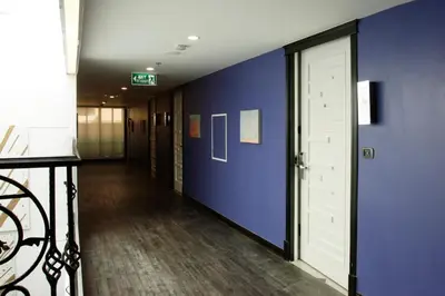 a hallway with a blue wall and a door at Aspira Skyy Sukhumvit 1 in Bangkok