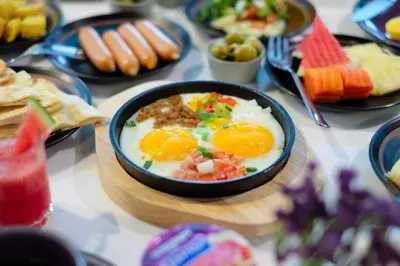 a table with a bowl of eggs and other food at Aspira Skyy Sukhumvit 1 in Bangkok