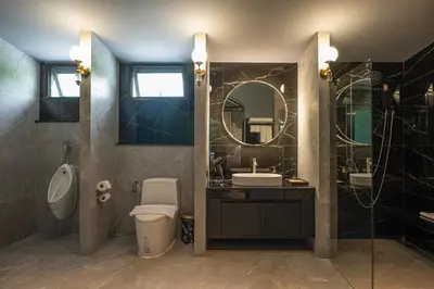 a bathroom with a toilet and a sink and a mirror at Bangkok Oasis Hotel in Bangkok