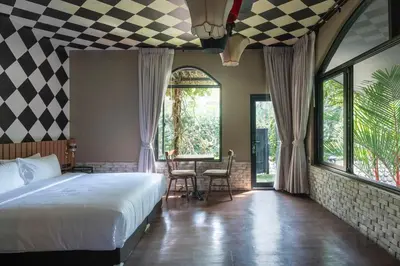 a bedroom with a bed and a checkerboard ceiling at Bangkok Oasis Hotel in Bangkok