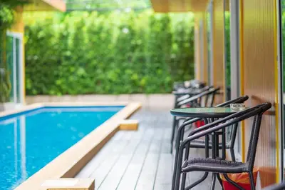 a porch with chairs and a swimming pool at Resort V - MRT Huai Khwang in Bangkok