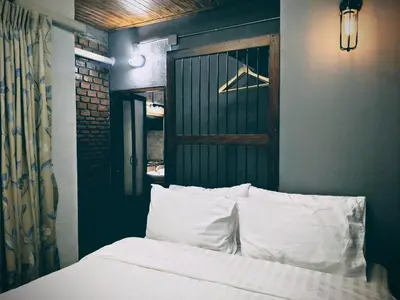 a bedroom with a bed with white pillows at Zeds Hostel Bangkok in Bangkok