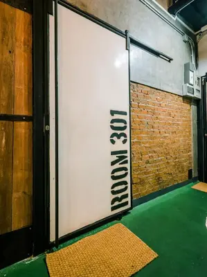 a large white sign in a room with a brick wall at Zeds Hostel Bangkok in Bangkok