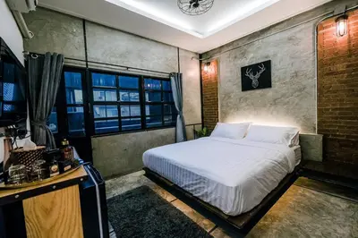 a bedroom with a bed and a clock on the wall at Zeds Hostel Bangkok in Bangkok