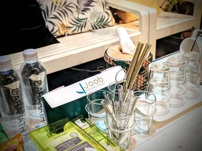 a shelf with glasses and bottles on a table at Zeds Hostel Bangkok in Bangkok