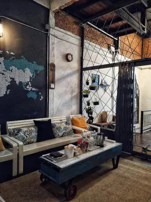 a living room with a couch and a table at Zeds Hostel Bangkok in Bangkok