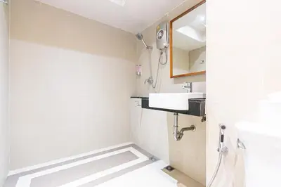 a bathroom with a sink and a mirror at A Room Bangkok Sathorn in Bangkok
