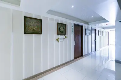a hallway of a building with white walls at A Room Bangkok Sathorn in Bangkok