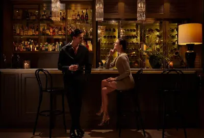 a man and a woman sitting at a bar at Oriental Residence Bangkok in Bangkok