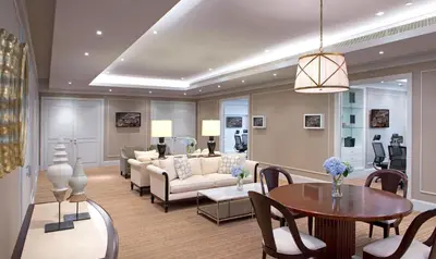 a living room with a couch and a table at Oriental Residence Bangkok in Bangkok