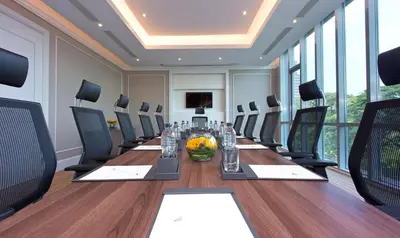 a conference room with a long table and chairs at Oriental Residence Bangkok in Bangkok